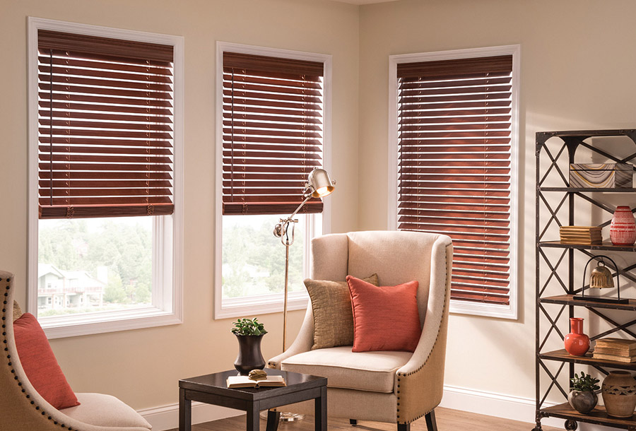 A cozy family room corner with warm sunlight filtering through faux-wwod blinds.