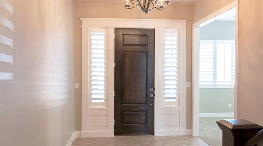 White Polywood shutters provide shade, privacy, and style for your entryway.